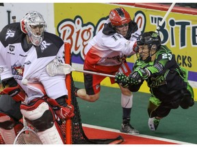 Saskatchewan Rush forward Jarrett Davis tries to jam a shot in from behind the crease against Calgary Roughnecks goalie Mike Poulin at the Scotiabank Saddledome in Calgary, Alta. on Saturday, May 14, 2016. The Rush beat the Roughnecks 16-10. (Mike Drew)