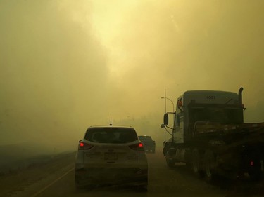 Smoke fills the air on Highway 63 southbound as residents of Fort McMurray leave the downtown area on Tuesday May 3, 2016. Robert Murray/Fort McMurray Today/Postmedia Network