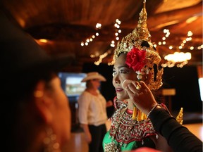 Kaew McKinnon with the Grand Thai Classical Dancers gets ready to perform at the Stampede's Rotary House on May 31, 2016, during the announcement of the new International Pavilion. Leah Hennel/Postmedia