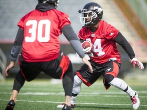 Roy Finch looks for a way past Rene Paredes during the Calgary Stampeders training camp in Calgary, Alta., on Monday, May 30, 2016. The regular season begins on June 25, when the Stamps head to B.C. Lyle Aspinall/Postmedia Network