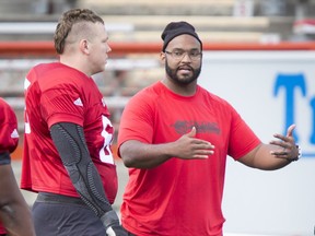 Guest coach Edwin Harrison chats with Dan Federkeil  during the Calgary Stampeders training camp at McMahon Stadium in Calgary, Alta., on Tuesday, May 31, 2016. The regular season begins on June 25, when the Stamps head to B.C. Lyle Aspinall/Postmedia Network