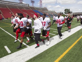 Defence jogs during the Calgary Stampeders training camp at McMahon Stadium in Calgary, Alta., on Tuesday, May 31, 2016. The regular season begins on June 25, when the Stamps head to B.C. Lyle Aspinall/Postmedia Network