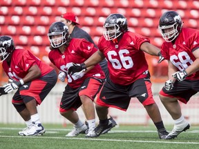 Ucambre Williams, Quinn Horton, Byron Pinkston and Roman Grozman line up during a drill on Day 1 of the Calgary Stampeders rookie camp at McMahon Stadium in Calgary, Alta., on Thursday, May 26, 2016. Regular training camp was set to begin on May 29.  Lyle Aspinall/Postmedia Network