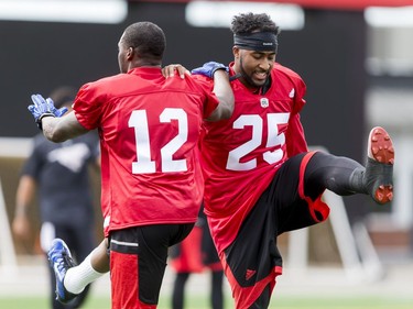 Roy Finch (L) and Lache Seastrunk warm up on Day 1 of the Calgary Stampeders rookie camp on Thursday, May 26, 2016.