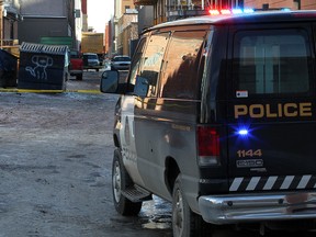 Police investigate the scene of the fatal stabbing of Lukas Strasser-Hird in an alley in the 200 block between 10th and 11th avenue S.W.