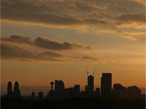 The sun sets with the downtown Calgary, AB skyline on the horizon on Wednesday April 27, 2016.