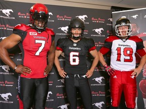 Calgary Stampeders players Junior Turner, Rob Maver and Bo Levi Mitchell pose with the team's newly styled uniforms which were unveiled on Thursday.