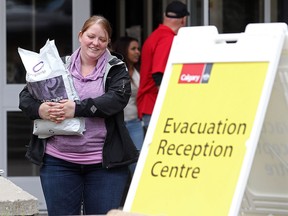 Amanda Morrisey of Fort McMurray hauls a bag of pet food  for her cat Lilly from the Evacuation Centre at University of Calgary Monday, May 9, 2016. She says she escaped Fort McMurray by car and eventually by air from Firebag with the cat, her two dogs and her 15-year-old.