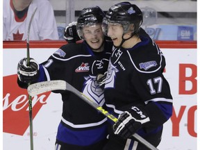 Victoria Royals Matthew Phillips, left, and Tyler Soy celebrate a goal against the Calgary Hitmen in WHL action at the Scotiabank Saddledome in Calgary, Alberta, on Friday, February 26, 2016. Mike Drew/Postmedia