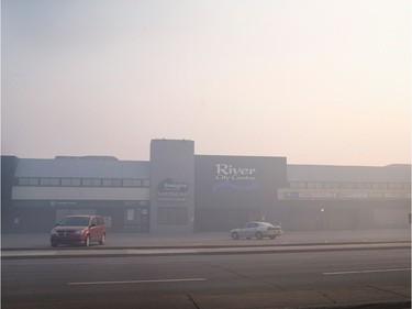 FORT MCMURRAY, AB - MAY 06:  Smoke from wildfires fill the morning air in front of a shopping center on May 6, 2016 in Fort McMurray, Alberta, Canada. Wildfires, which are still burning out of control, have forced the evacuation of more than 80,000 residents from the town.