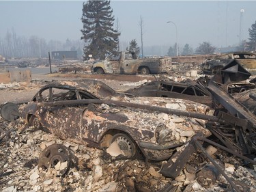 The remains of a classic Triumph GT6 sit in a residential neighborhood destroyed by a wildfire in Fort McMurray.