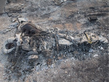 FORT MCMURRAY, AB - MAY 06:  The remains of a charred snowmobile sit in a residential neighborhood destroyed by a wildfire on May 6, 2016 in Fort McMurray, Alberta, Canada Wildfires, which are still burning out of control, have forced the evacuation of more than 80,000 residents from the town.