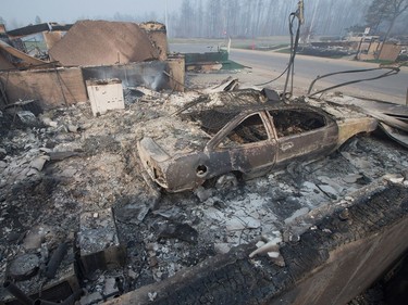 Home foundations and shells of vehicles are nearly all that remain in a residential neighborhood destroyed by a wildfire in Fort McMurray.