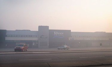 Smoke from wildfires fill the morning air in front of a shopping center on May 6, 2016 in Fort McMurray, Alberta, Canada. Wildfires, which are still burning out of control, have forced the evacuation of more than 80,000 residents from the town.