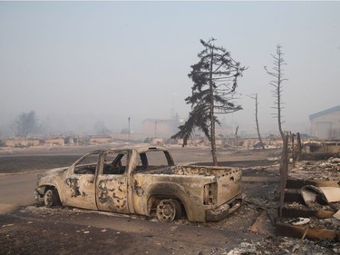 Home foundations and shells of vehicles are nearly all that remain in a residential neighborhood destroyed by a wildfire on May 6, 2016 in Fort McMurray, Alberta, Canada Wildfires, which are still burning out of control, have forced the evacuation of more than 80,000 residents from the town.