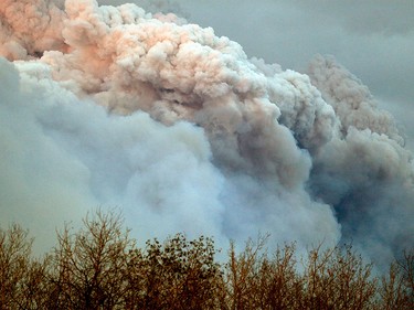 A plume of smoke from a wildfire near Fort McMurray Alberta is lit up at sunset on May 4, 2016. A wildfire has forced the evacuation of Fort McMurray, the fourth largest city in Alberta.