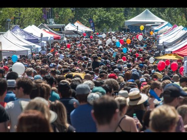 A huge crowd throngs the road at the annual 4th Street Lilac Festival in Calgary, Ab., on Sunday June 5, 2016. Mike Drew/Postmedia