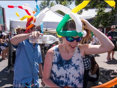 Balloon People Chris Visser and Patricia Taylor cool off at the annual 4th Street Lilac Festival in Calgary, Ab., on Sunday June 5, 2016. Mike Drew/Postmedia