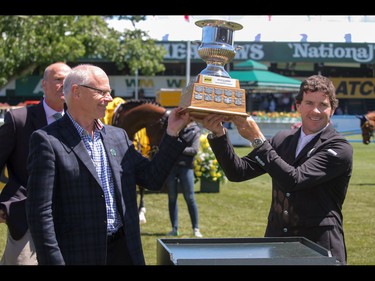 Ireland's Conor Swail , right, and ATCO Structures Stephen Lockwood hoist the winner's cup in the ATCO Classic at the Spruce Meadows National in Calgary, Ab., on Sunday June 12, 2016. Mike Drew/Postmedia