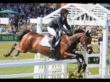Lisa Carlsen and World's Judgement on their way to a second place finish in the Nexen Cup at the Spruce Meadows National in Calgary, Ab., on Sunday June 12, 2016. Mike Drew/Postmedia