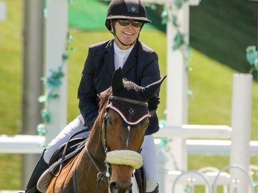 Lisa Carlsen and World's Judgement on their way to a second place finish in the Nexen Cup at the Spruce Meadows National in Calgary, Ab., on Sunday June 12, 2016. Mike Drew/Postmedia