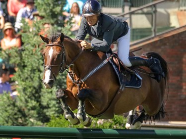 USA's Richard Spooner and Cristallo on their way to a first finish in the Nexen Cup at the Spruce Meadows National in Calgary, Ab., on Sunday June 12, 2016. Mike Drew/Postmedia