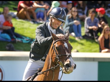 USA's Richard Spooner and Cristallo celebrate their first finish in the Nexen Cup at the Spruce Meadows National in Calgary, Ab., on Sunday June 12, 2016. Mike Drew/Postmedia