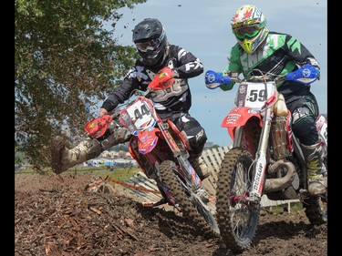 Al Wilson jostles with Kevin Pelletier at the Redbull Chasing Limits Motor Cross competition in Calgary on June 22, 2016.