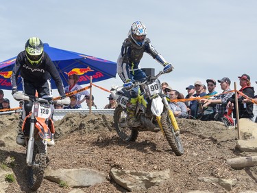 Clint Boos and Wyatt Hart drive over rocks and logs at the Redbull Chasing Limits Motor Cross competition in Calgary on June 26, 2016. Hundreds of people attended the competition, held at Wild Rose MX Park.