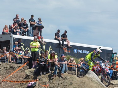 Fans clamour for a spot while watching motocross at the Redbull Chasing Limits Motor Cross competition in Calgary on June 26, 2016. Hundreds of people turned out to watch, despite the rain creating muddy conditions.