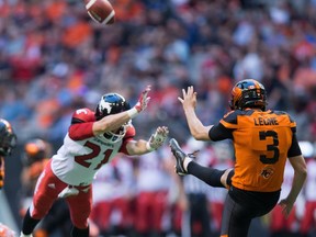 Calgary Stampeders' Adam Berger, left, nearly blocks a punt by B.C. Lions' Richie Leone during the first half of a CFL football game in Vancouver, B.C., on Saturday June 25, 2016.