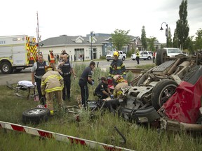 Airdrie Fire Department and EMS crews intervene to extract and perform first-aid on a single male occupant in his mid-80s at the intersection of 1st Ave and the train tracks on Thursday June 16, 2016 in Airdrie, Alta. The driver was declared deceased on scene following a collision in his red Ford pickup with a train around 2 p.m.
(Britton Ledingham/Airdrie Echo/Postmedia Network)