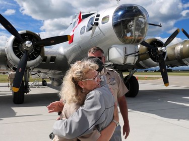 94 year-old Canadian World War II veteran Doug Curtis gets a hug from pilot Lorraine Morris after a flight in Aluminum Overcast, a B-17 Flying Fortress, at Springbank Airport outside Calgary on Wednesday June 22, 2016. The WW II bomber is owned by the U.S. based Experimental Aircraft Association who will take people on flights in the vintage aircraft. Flights are used as a fundraiser for the organization to help restore and maintain vintage aircraft. Curtis was a Royal Air Force tail gunner in a Lancaster bomber.