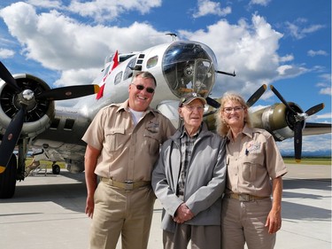94 year-old Canadian World War II veteran Doug Curtis stands with pilots Ken and Lorraine Morris after a flight in Aluminum Overcast, a B-17 Flying Fortress, at Springbank Airport outside Calgary on Wednesday June 22, 2016. The WW II bomber is owned by the U.S. based Experimental Aircraft Association who will take people on flights in the vintage aircraft. Flights are used as a fundraiser for the organization to help restore and maintain vintage aircraft. Curtis was a Royal Air Force tail gunner in a Lancaster bomber.