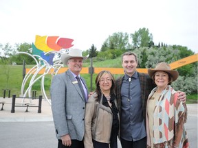 Bill Gray, president and chair of the Calgary Stampede Board of Directors, Patti Pon, board member, Calgary Foundation, Jeff de Boer, artist, Ann McCaig, Calgary Stampede Foundation, stand in front of Rainbow Trout.