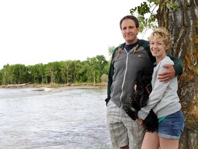 High River mayor Craig Snodgrass and his wife Lindsay, with their dog Simon, on the banks of the Highwood River in June 2014.