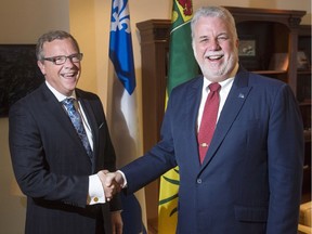 Saskatchewan Premier Brad Wall, left, and Quebec Premier Philippe Couillard shake hands before their meeting Thursday in Montreal to discuss the Energy East pipeline.