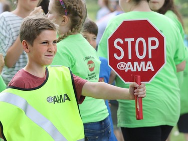 Matthew Jost from St. Philip school does a demonstration crossing during a fun-filled day appreciation day at Heritage Park on Thursday June 9, 2016 for AMA School Safety Patrollers. Patrollers have been keeping kids safe in crosswalks for 79 years since 1937.
Gavin Young/Postmedia