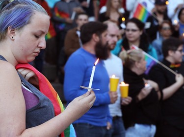 Calgarians take part in a vigil in Olympic Plaza  on Sunday evening June 12, 2016 for the victims of the Pulse Nightclub shooting in Orlando.