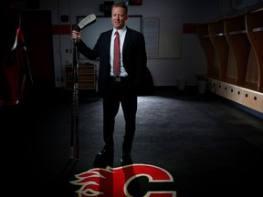 New Calgary Flames head coach Glen Gulutzan poses for a portrait inside the Flames dressing room at the Scotiabank Saddledome in Calgary on June 17, 2016.