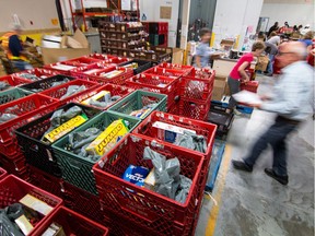 Volunteers at the Calgary Inter-Faith Food bank fill hampers at their warehouse in Calgary, Ab., on Friday June 3, 2016. Mike Drew/Postmedia