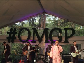 Calgary philanthropist W. Brett Wilson talks to the attendees at his annual Garden Party in his backyard, on June 21, 2016, while sporting an outfit that matches the flamingo pink theme of the event. Behind him is the band John and Jacob, one of several entertainment acts at the garden party, which also featured Brett Kissel and Oscar Lopez. Monica Zurowski, Postmedia News