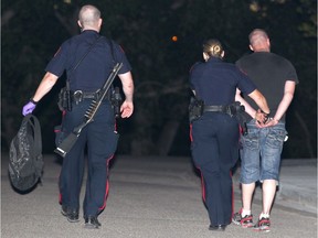 Calgary Police take a man into custody on Roselawn Crescent N.W. at about 10 p.m. in Calgary on Tuesday, June 21, 2016. Police say a homeowner held what he deemed was a suspicious person at gunpoint. Both men were detained. No one was injured.