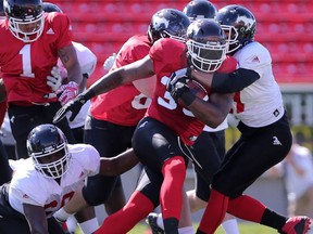 Calgary Stampeders Jerome Messam runs the ball during the teams intrasquad mock game at McMahon Stadium in Calgary, Alta.. on Sunday June 5, 2016. Leah hennel/Postmedia