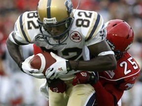 Calgary Stampeders, Keon Raymond, tackles Winnipeg Blue Bombers, Terrence Edwards, in first half action at McMahon on Saturday July 31, 2010.