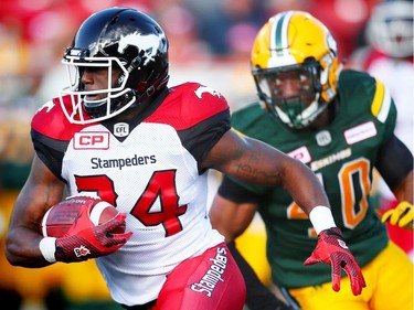 Calgary Stampeders Tory Harrison avoids a tackle by Deon Lacey of the Edmonton Eskimos in CFL pre-season action at Calgary's McMahon Stadium on June 11, 2016.