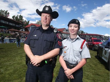 Calgary Police cadet superintendent Madeleine Gibson joins Calgary Police Sergeant Mark Kane on the field during the Destination Fort McMuuray parade with first responders at Spruce Meadows on day four  of The National.