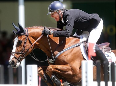 Rich Fellers rides Flexible through a clean run in the RBC Grand Prix at Spruce Meadows on day four of The National June 11, 2016.