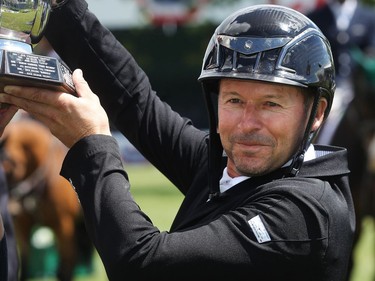 Canadian Eric Lamaze lifts the trophy after winning the TransCanada Winning Round at Spruce Meadows on day four of The National June 11, 2016.