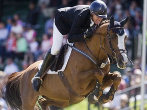 Rich Fellers rides Flexible through a clean run in the RBC Grand Prix at Spruce Meadows on day four of The National June 11, 2016.